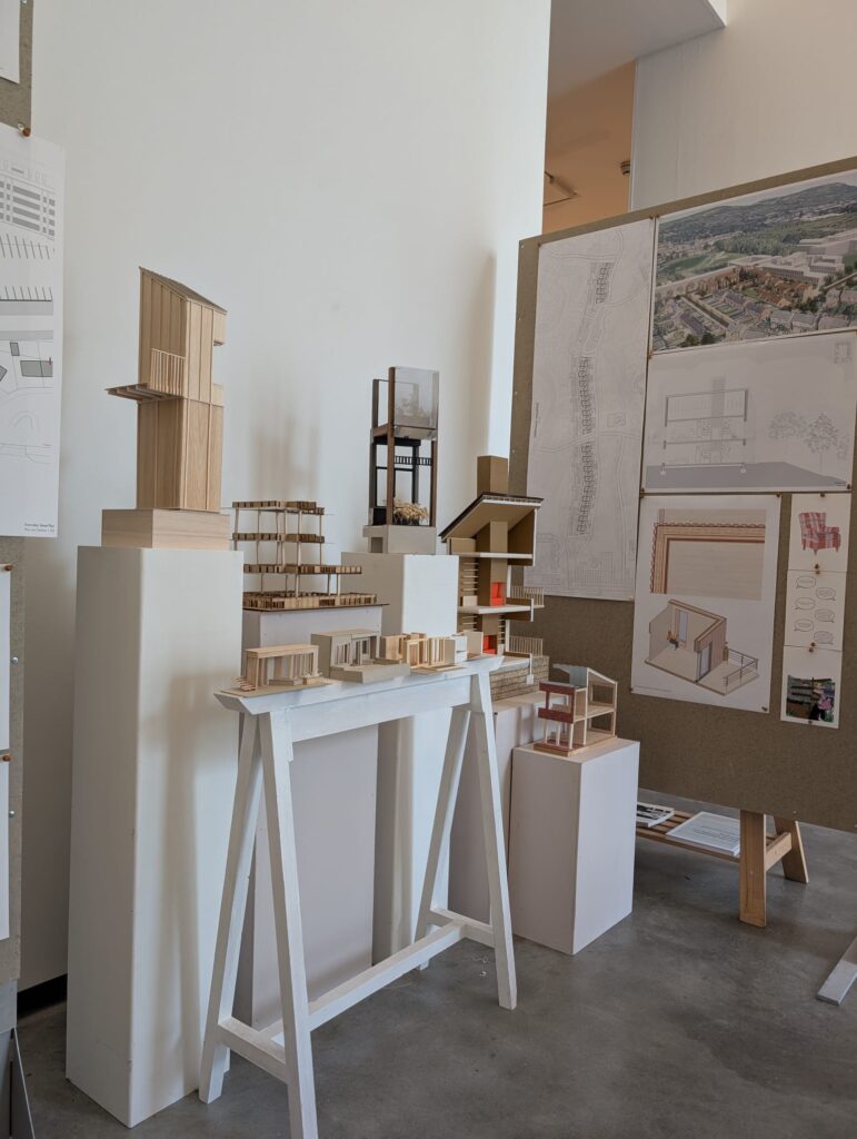 Gallery space at the MAC shows architectural drawings, renderings and 3D building models for a proposed housing development.